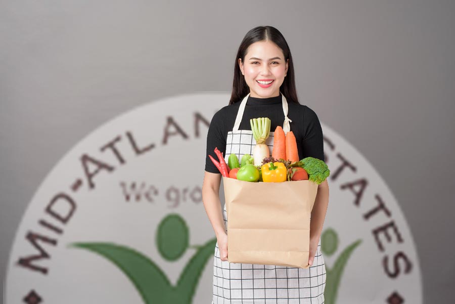 Smiling woman holding bag of groceries