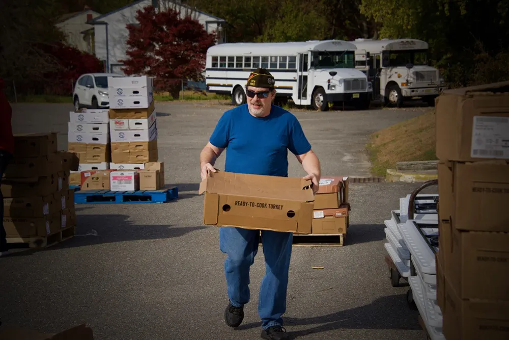 Volunteer carrying a box
